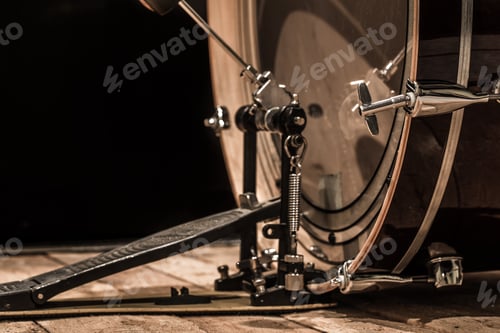 Preview: percussion instrument, bass drum with pedal on wooden boards with a black background