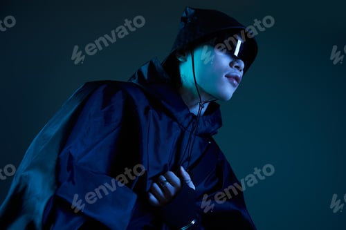 Preview: Stylish young man in a dark outfit showcases modern fashion trends with confidence