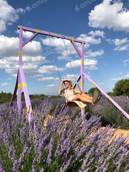 Preview: girl swinging on a swing on a lavender field