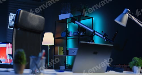 Preview: Office desk filled with business items in empty home interior with TV left open