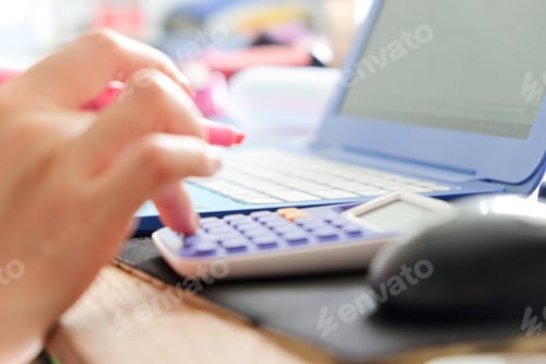 Preview: close up female hands of accountant with calculator