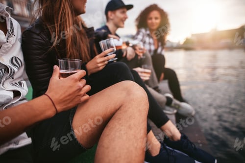 Preview: Group of people sitting on pier and having drinks