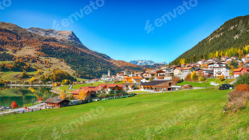 Preview: Bright autumn view of San Valentino village and Muta lake (Haidersee)
