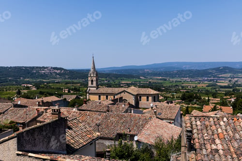 Preview: beautiful traditional architecture, rooftops and distant mountains in Bonnieux, France