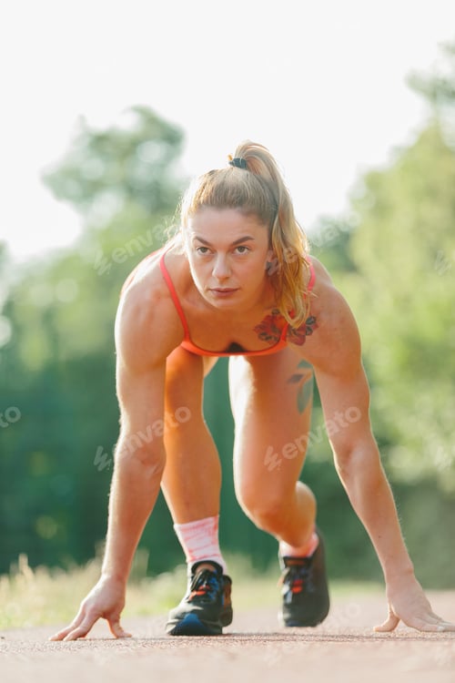 Preview: Female athlete preparing for intense outdoor training run
