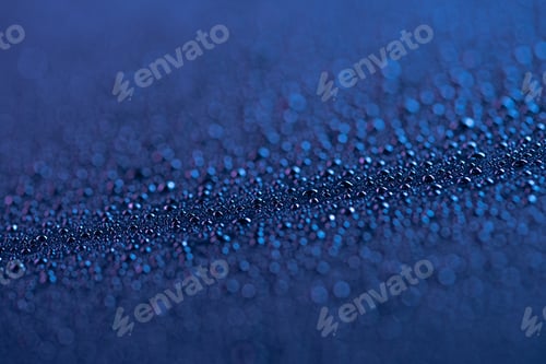 Preview: selective focus of water drops on blue surface as background