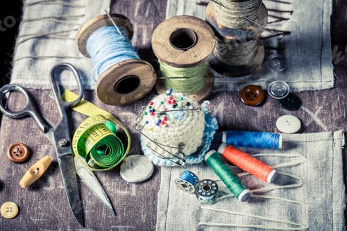Preview: Vintage scissors, threads and needle on wooden table