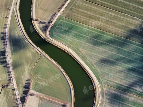 Preview: Drone shot of a river in a field