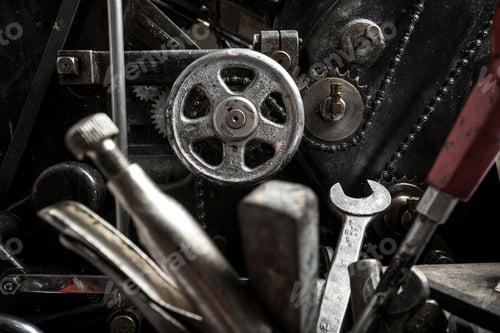 Preview: Tools near printing machinery in printing press workshop