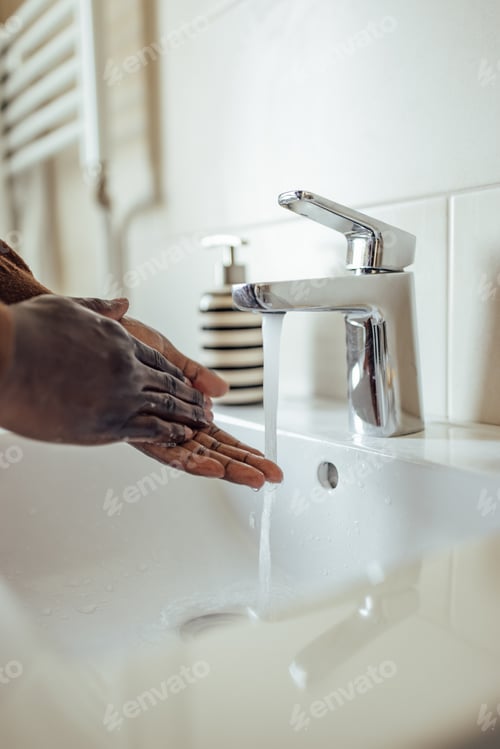 Preview: A pair of hands, being cleaned with a soap.