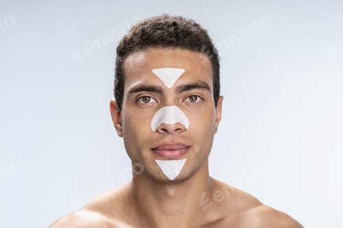 Preview: Serious man using special skin care treatment