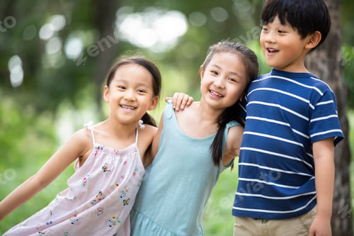 Preview: Three Chinese children playing on grass