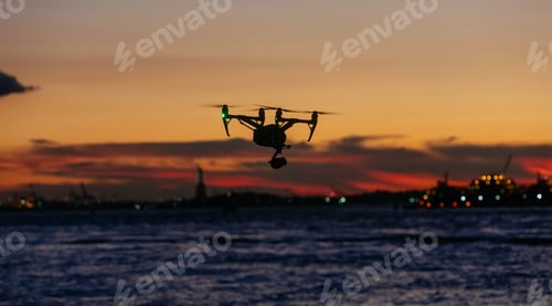 Preview: Flying drone against colored the background of New York at sunset