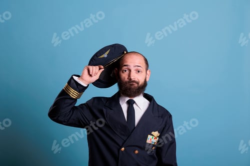 Preview: Confused airplane pilot taking hat off, looking at camera
