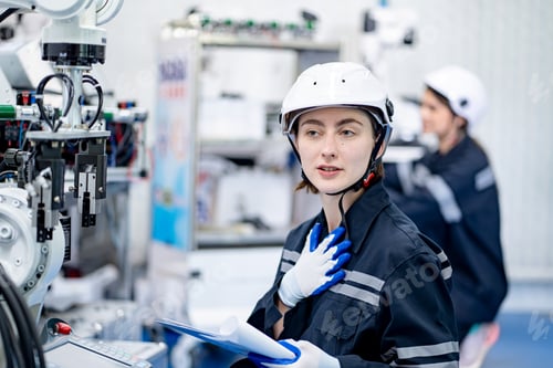 Preview: Female engineers working on robotics in industry factory. Technology, people and engineering concept
