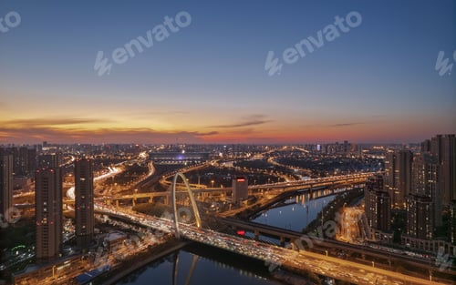 Preview: Aerial shot of the Zhicheng Road Interchange over the river in Haihe, Tianjin, China at sunset