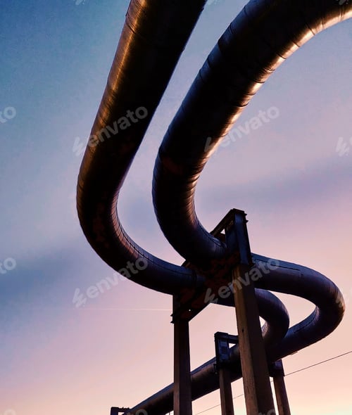 Preview: Low angle of live steam pipeline fixed above the ground with huge stone constructions