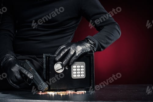 Preview: Close-up view of robber with gun taking bitcoin from safe