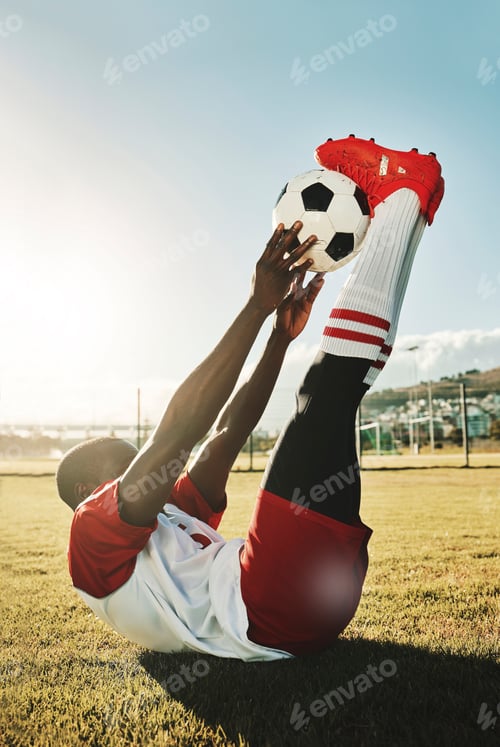 Preview: Soccer, sports and stretching with a black man athlete training with a ball before a game or match