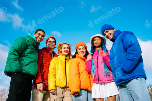 Preview: Multiracial group of young friends meeting outdoors in winter
