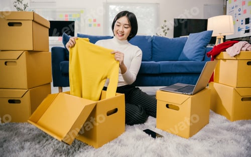 Preview: Online seller preparing clothes for shipping in her home office