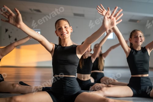 Preview: Group of young fit dancers practicing during class school