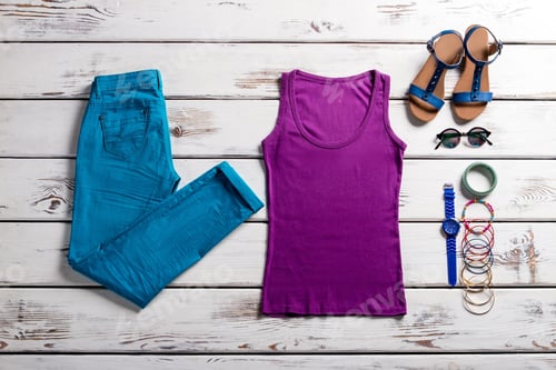 Preview: Colorful clothes on wooden background.