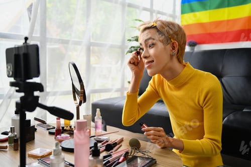 Preview: Happy young gay man blogger recording make up tutorial, live streaming at home.