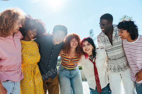 Preview: Multiethnic group of young friends meeting and having fun outdoors