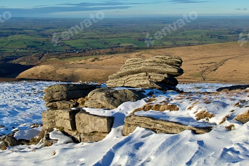 Preview: Large rock formation standing on the Yes Tor peak with an idyllic winter landscape in background