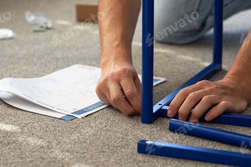 Preview: Diy furniture assembly scene with hands and instructions for home improvement