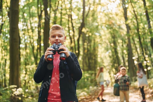 Preview: Founding the way. Kids in green forest at summer daytime together