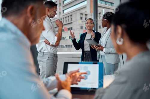Preview: Shot of a group of businesspeople brainstorming with notes on a window in an office