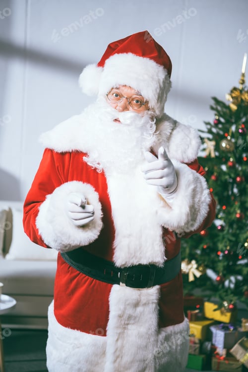 Preview: portrait of santa claus looking and pointing at camera