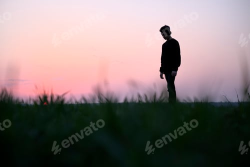 Preview: Teenager on green lawn listening music