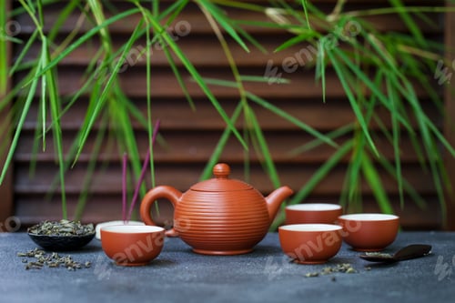 Preview: Green Tea in Tea Pot and Chawan Bowls, Cups on Slate Background. Copy Space.