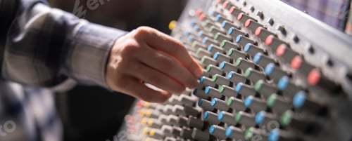 Preview: a Close-Up of a Hand Adjusting the Controls on a Music Mixer Console in a Studio