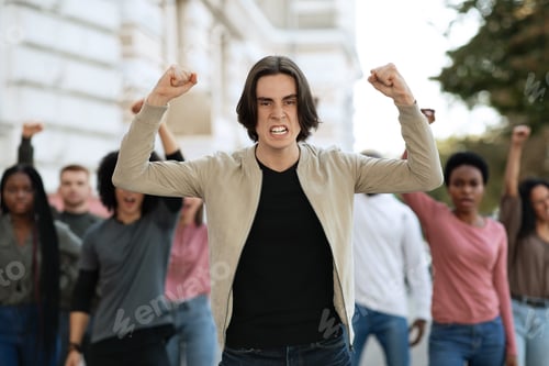 Preview: Male activist leading multiracial group of people protesting against lockdown