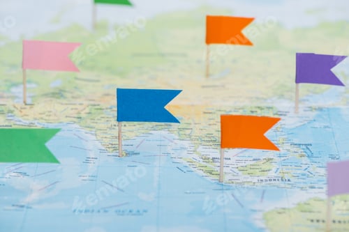 Preview: close up view of colorful flag pins on world map