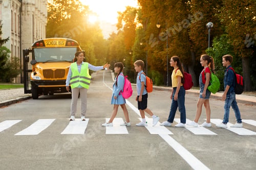 Preview: Road Traffic Safety. School Bus Assistant Helping Kids Cross Road By Crosswalk