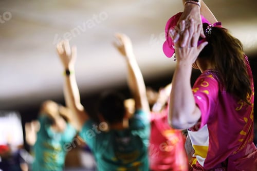 Preview: Woman wearing pink sport shirt warm up before marathon event closeup blur people group background