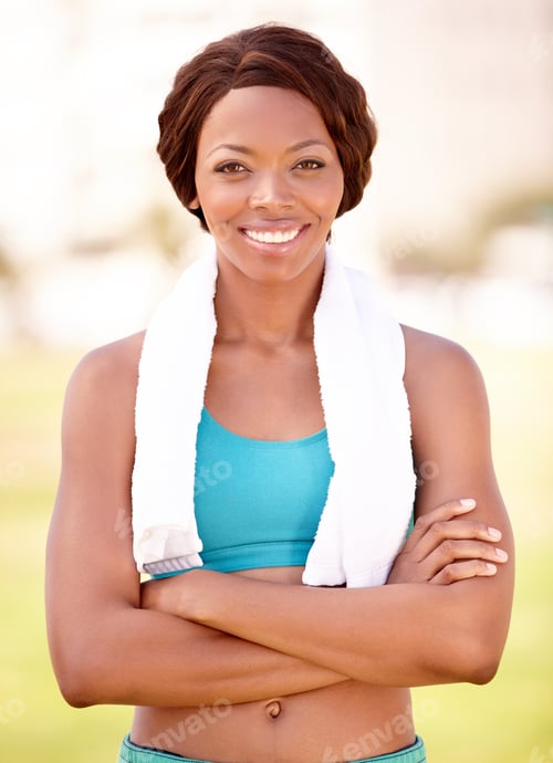 Preview: A pretty young woman in sportswear with a towel around her neck