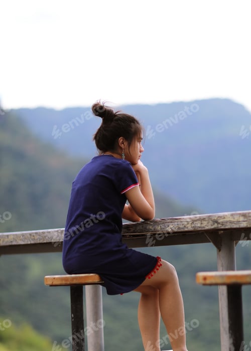 Preview: Teenager girl sitting thought in nature mountain landscape blur outdoor background