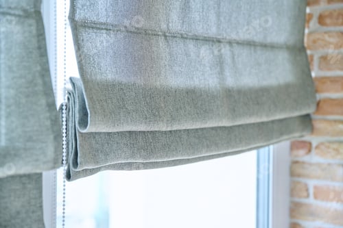 Preview: Close-up of roman blinds with gray linen fabric