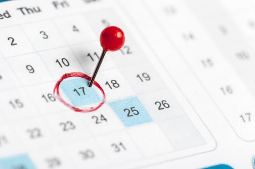 Preview: Important date marked on calendar with red circle and pin in a home office setting