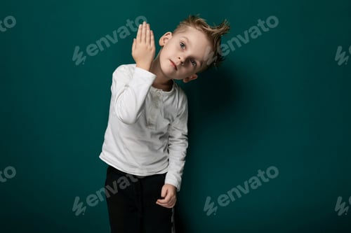 Preview: Young Boy Standing in Front of Green Wall