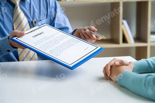 Preview: Male arm in shirt offers contract form on clipboard pad and silver pen to sign closeup. sale insura
