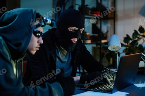 Preview: Young Adult Men Breaking into Office Computer System during Nighttime Robbery