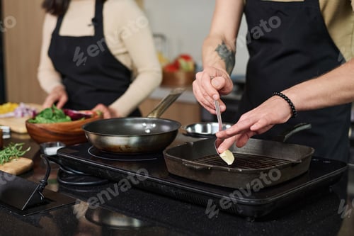 Preview: Man Putting Butter on Pan