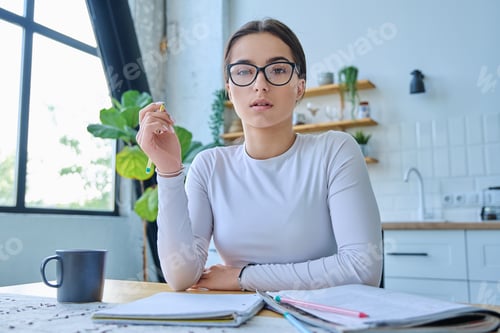 Preview: Young Woman Studying at Home at Wooden Desk